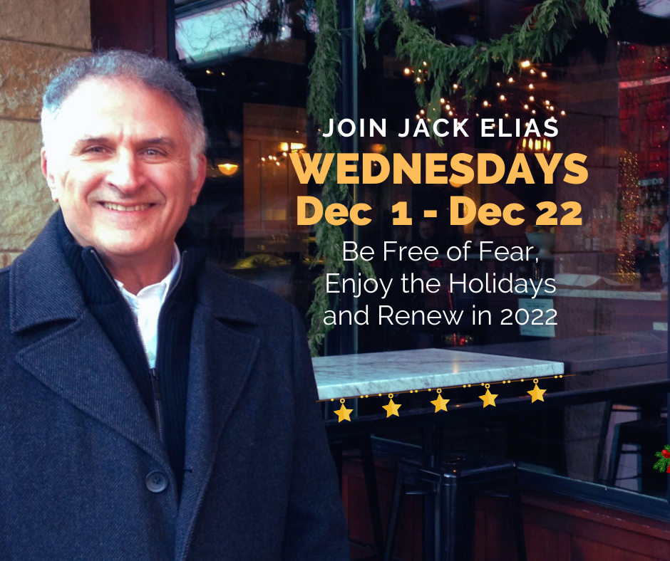 Wearing a charcoal gray wool dress coat and white shirt, Jack, smiling, stands in front of a festive restaurant decorated with garlands of evergreens and gold stars